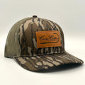 Coosa Cotton- Leather Patch Trucker Hat- Mossy Oak Bottomland ™️